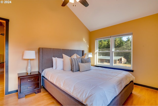 bedroom featuring high vaulted ceiling, light wood-type flooring, and ceiling fan