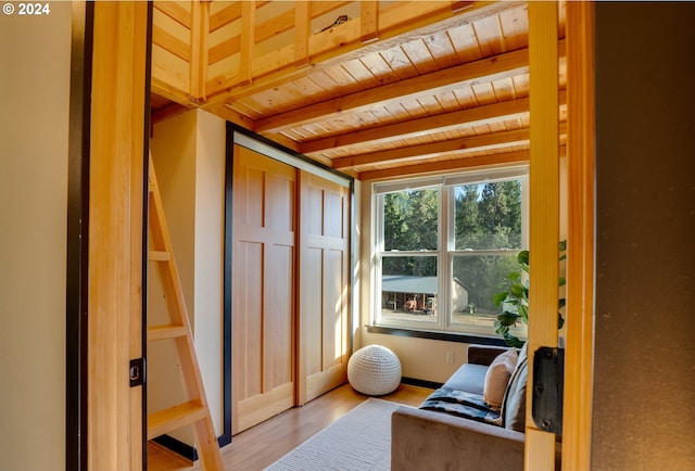 sunroom featuring beamed ceiling and wooden ceiling