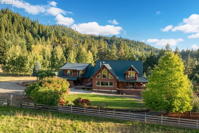 rear view of property with a porch and a rural view