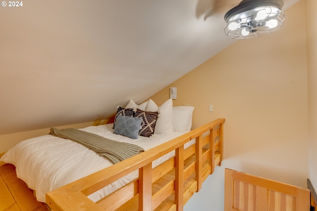 bedroom featuring wood-type flooring and vaulted ceiling