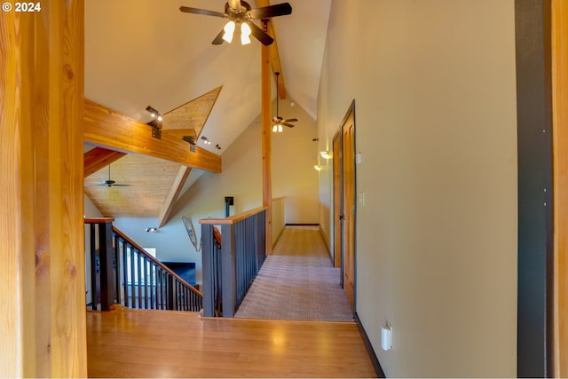 hallway with high vaulted ceiling, wood ceiling, beam ceiling, and hardwood / wood-style floors