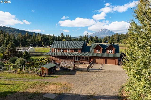 view of front of property with a mountain view and a garage