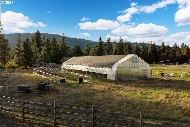 view of horse barn with a rural view