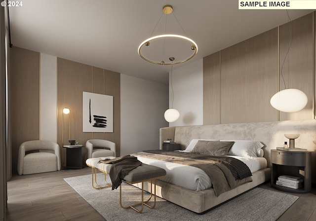 bedroom featuring light hardwood / wood-style flooring and a chandelier