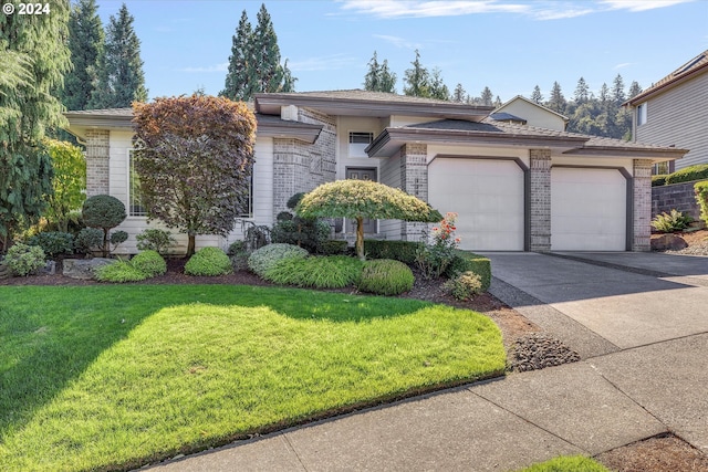 view of front of property with a garage and a front yard