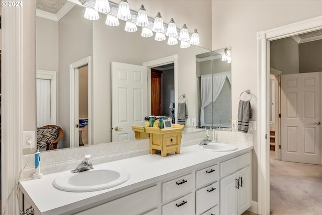 bathroom with ornamental molding and vanity