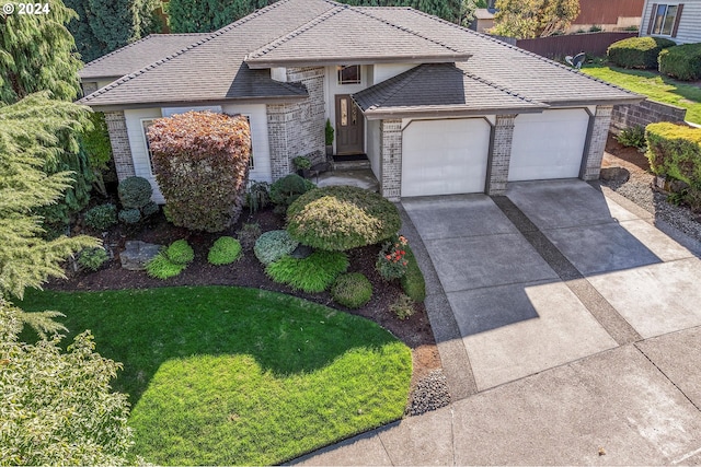 view of front of house featuring a garage and a front lawn