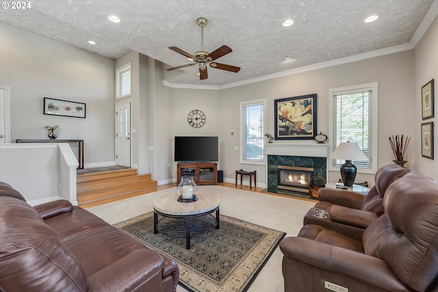 living room featuring a textured ceiling, a premium fireplace, and light hardwood / wood-style floors