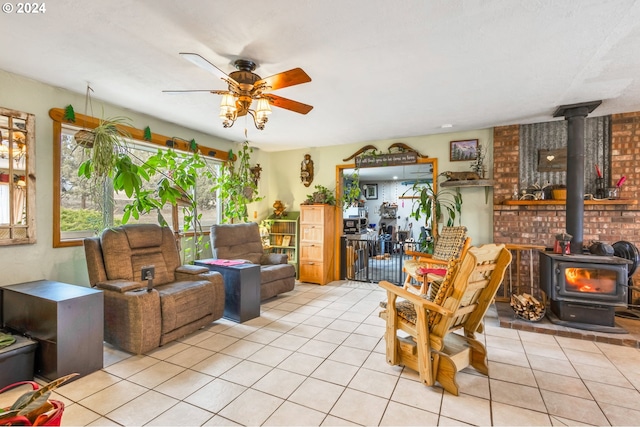 tiled living room with a wood stove and ceiling fan