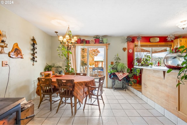 tiled dining space featuring a chandelier