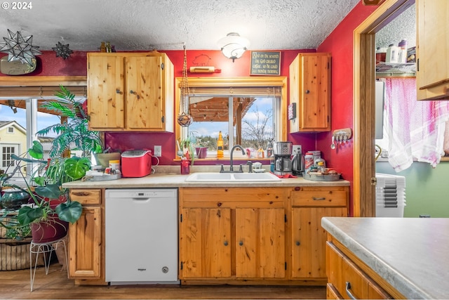 kitchen with a textured ceiling, wood-type flooring, sink, and white dishwasher