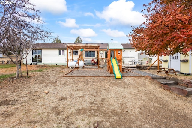 rear view of house with a playground