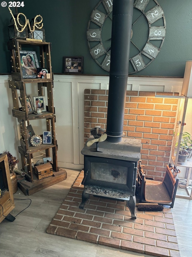 room details featuring a wood stove and hardwood / wood-style floors