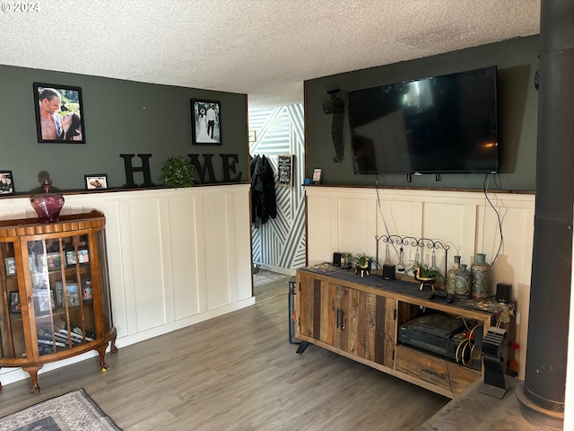 living room featuring hardwood / wood-style floors and a textured ceiling