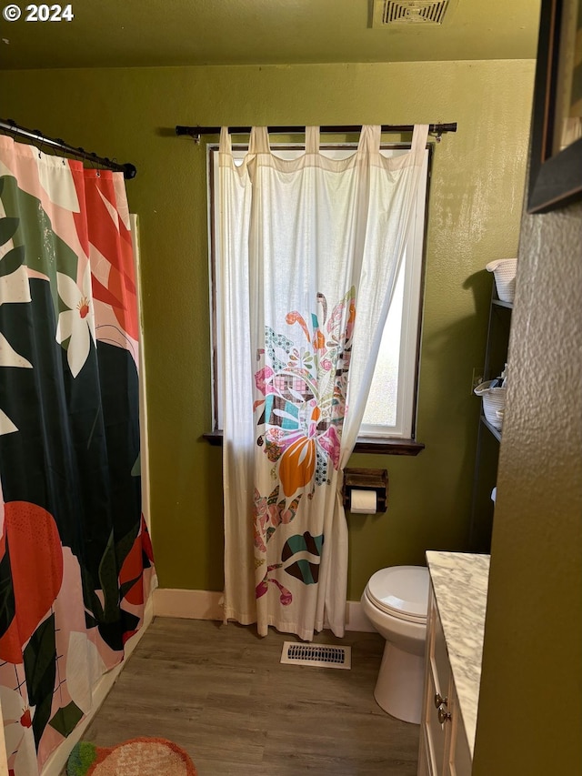 bathroom featuring hardwood / wood-style floors, vanity, toilet, and a shower with curtain