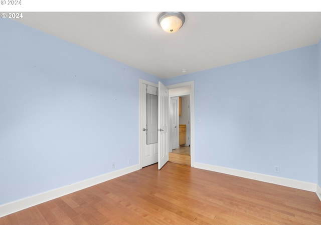 unfurnished room with light wood-type flooring