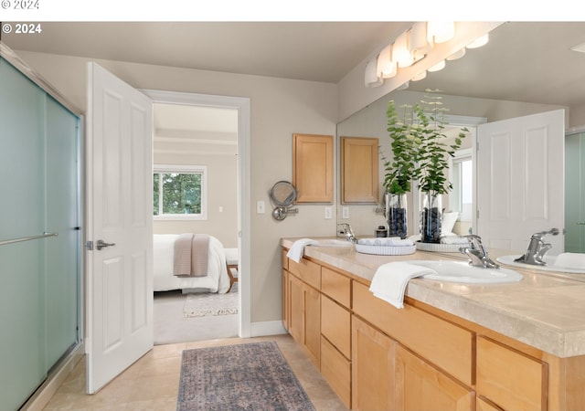 bathroom featuring double vanity, a stall shower, connected bathroom, a sink, and tile patterned floors