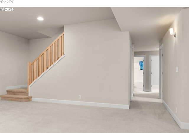 interior space with light carpet, stairs, baseboards, and recessed lighting