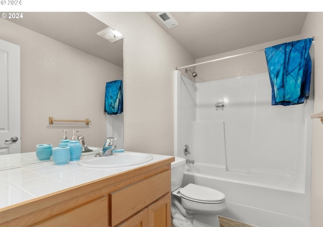 bathroom featuring visible vents, vanity, toilet, and tub / shower combination