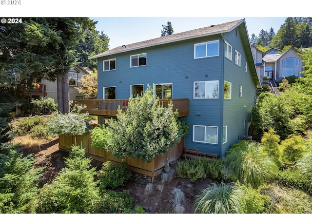 rear view of property with a storage unit