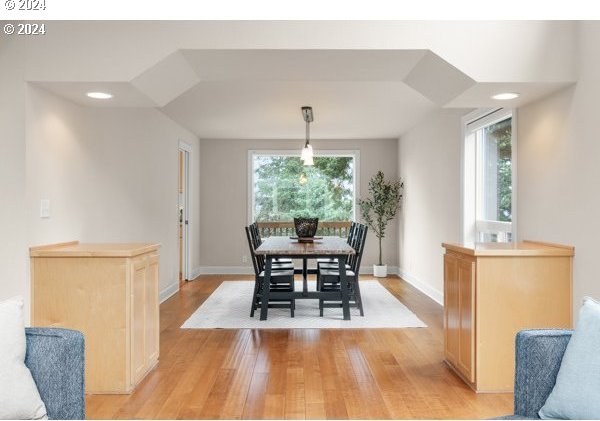 dining space with light wood finished floors and baseboards