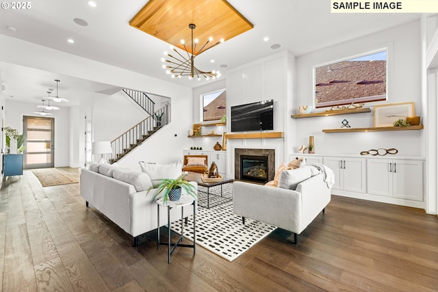 living room with a notable chandelier and dark hardwood / wood-style floors