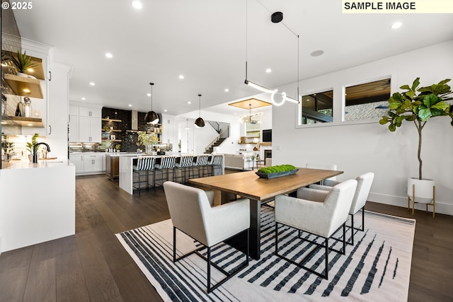 dining space featuring sink and dark wood-type flooring