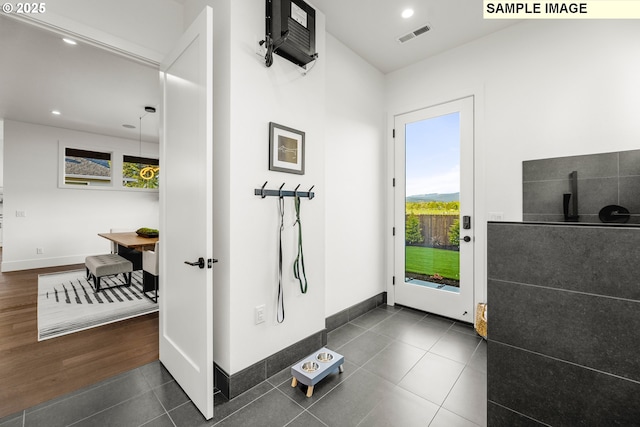 doorway with dark tile patterned flooring