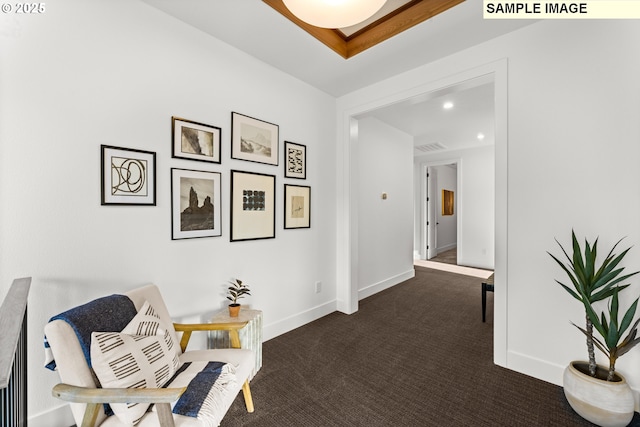 sitting room featuring dark colored carpet