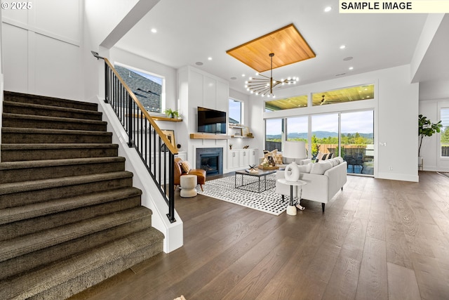 living room with dark hardwood / wood-style floors and an inviting chandelier