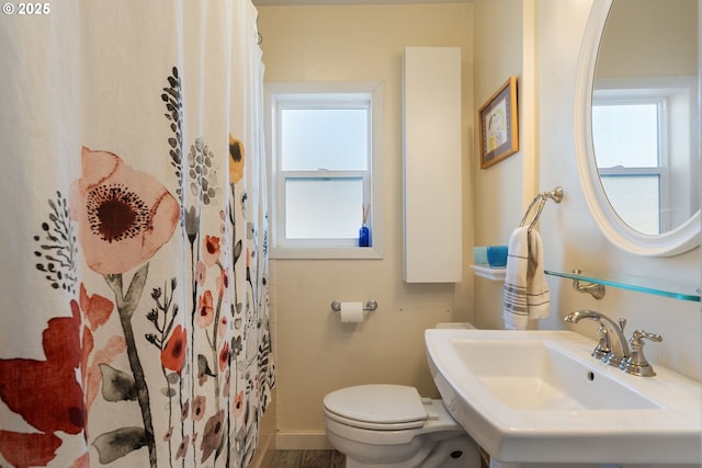 bathroom with sink, plenty of natural light, and toilet