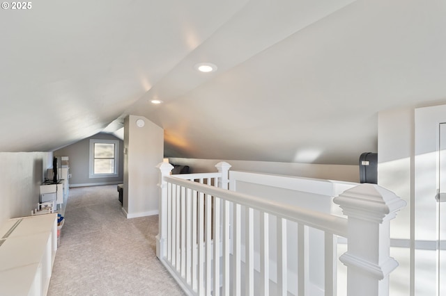 hall with light colored carpet and lofted ceiling