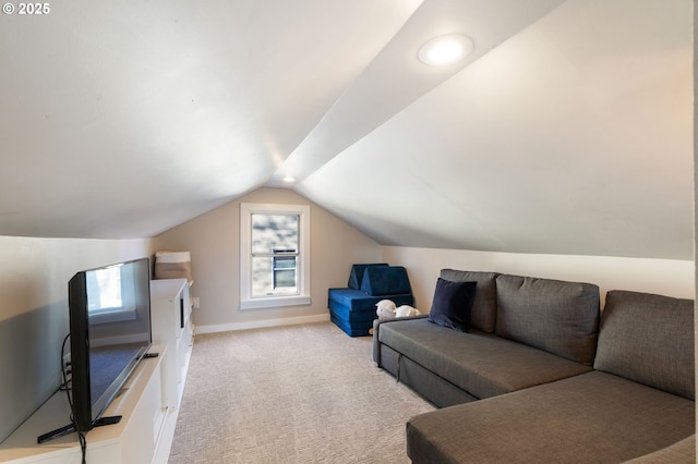 carpeted living room featuring lofted ceiling