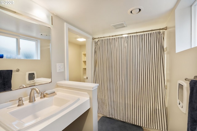 bathroom with sink and walk in shower