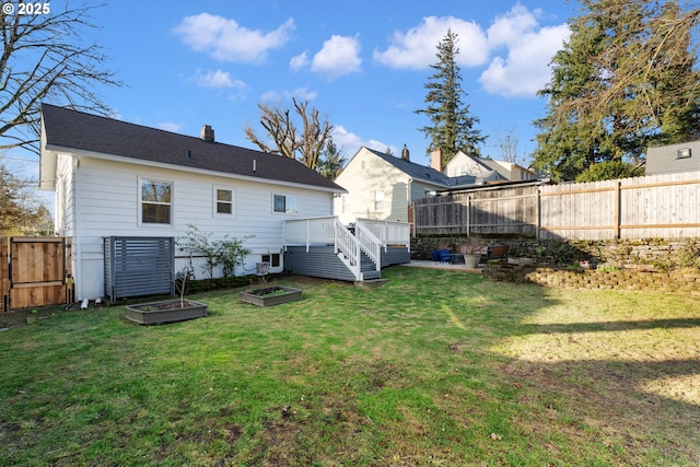 rear view of house with a deck and a lawn