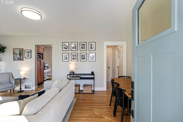 living room with light hardwood / wood-style flooring