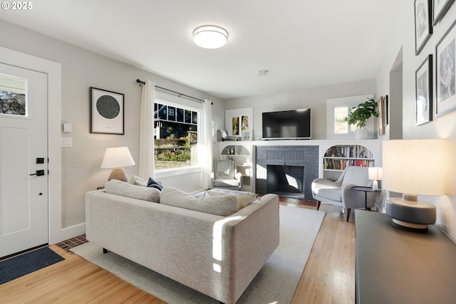 living room featuring light hardwood / wood-style floors and a fireplace