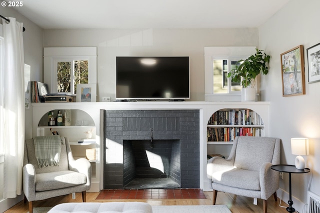 sitting room featuring a fireplace and hardwood / wood-style floors