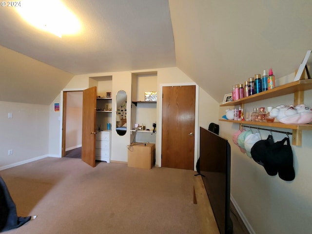 interior space featuring lofted ceiling and light colored carpet