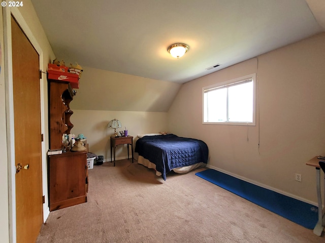 bedroom featuring carpet flooring and vaulted ceiling