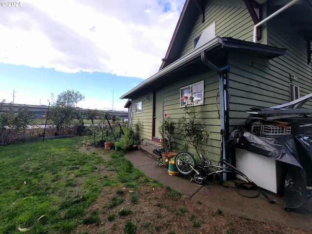 view of property exterior with a lawn