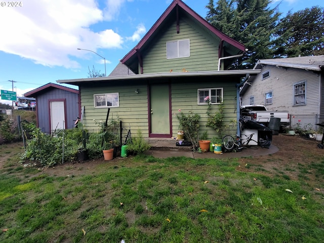 back of property with a lawn