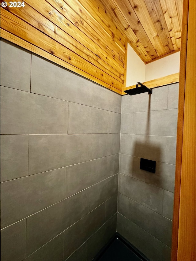 bathroom with wooden ceiling and tiled shower