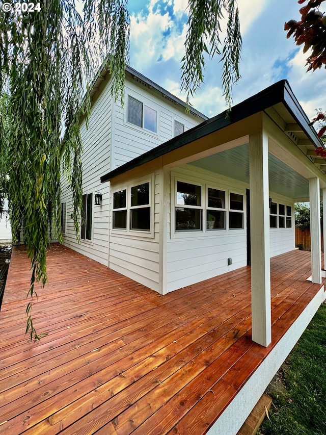 wooden terrace with an attached garage