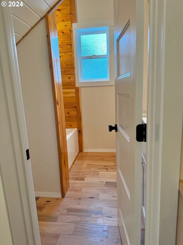 bathroom with vanity, hardwood / wood-style flooring, and plus walk in shower