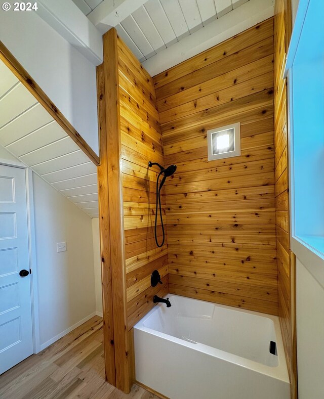 bathroom featuring washtub / shower combination, wooden ceiling, beamed ceiling, wooden walls, and hardwood / wood-style flooring