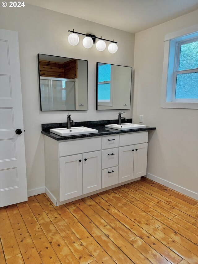 bathroom with vanity, hardwood / wood-style floors, and walk in shower