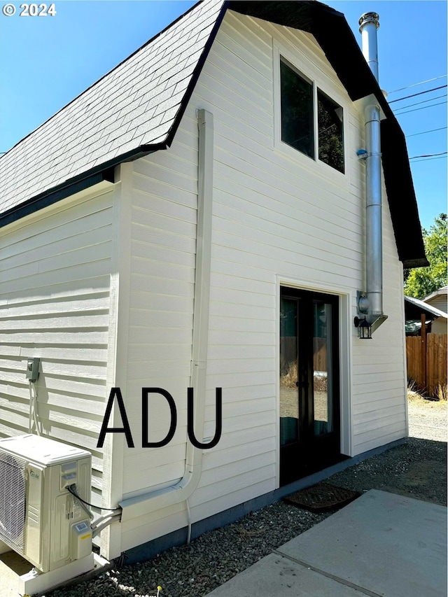 view of side of home with ac unit