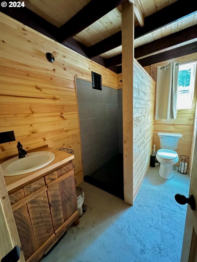 bathroom featuring toilet, beamed ceiling, a shower, vanity, and wood walls