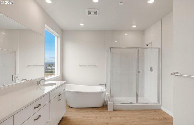 bathroom featuring a stall shower, wood finished floors, and visible vents